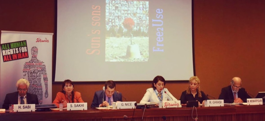 Speakers at a conference panel table