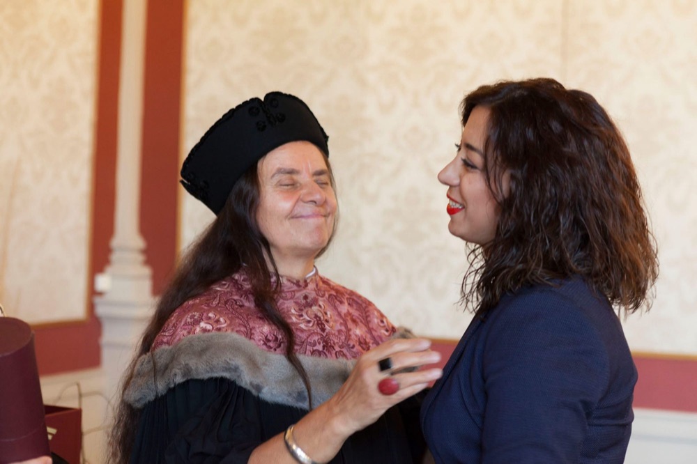 Parastoo Fatemi congratulated by a professor in academic robes